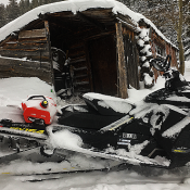 Snowmobile by shed